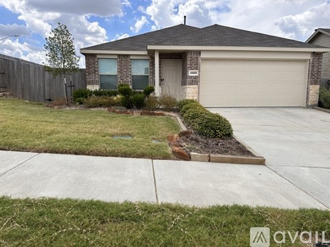 A house with a garage and a driveway in front.