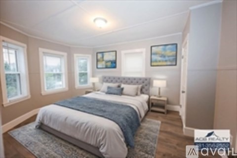 A bedroom with a large bed and a window.