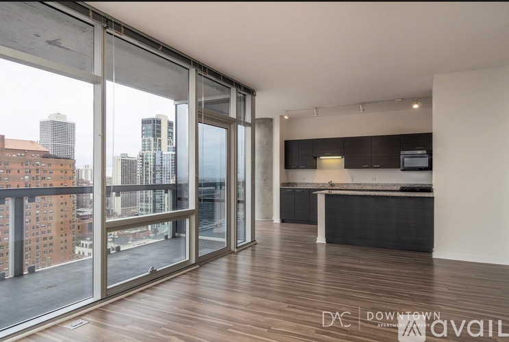 A spacious room with a view of the cityscape outside the large windows.