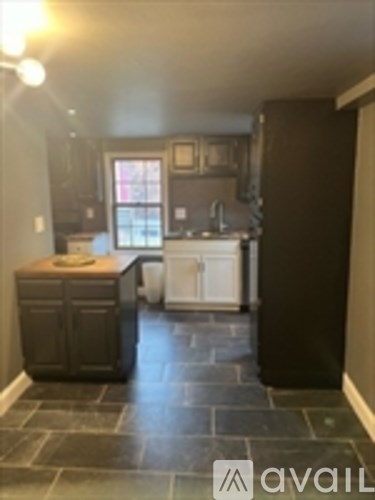 A kitchen with a white dishwasher and wooden countertops.