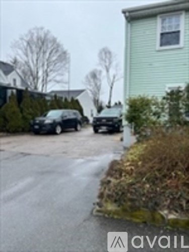 Two cars are parked in a driveway.