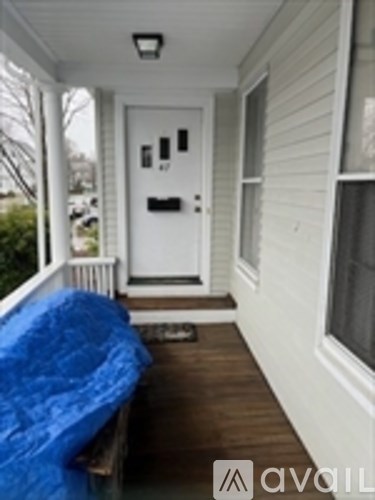 A white door with a black handle and a window to the right.