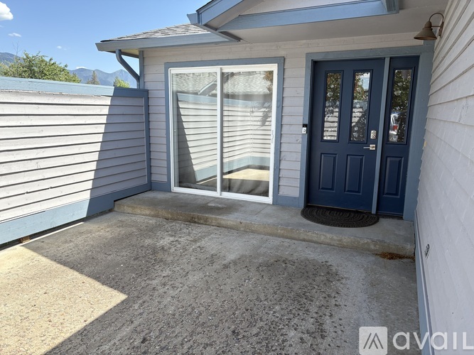 A house with a blue door and a glass window.