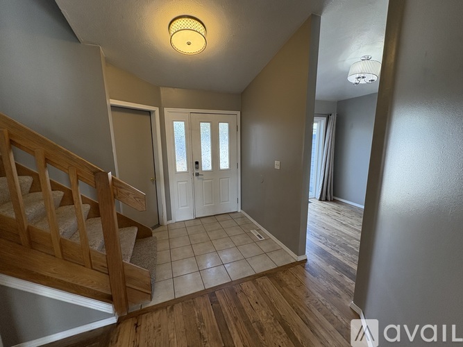 A hallway with a staircase leading to the second floor.