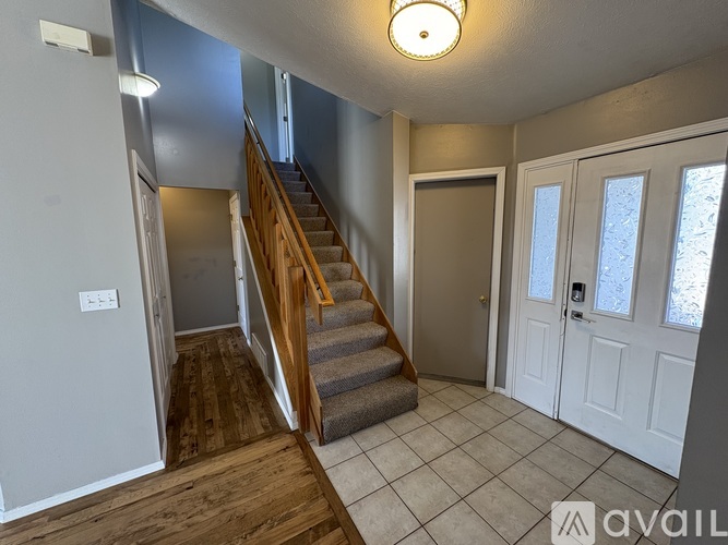 A room with a staircase leading to the upper floor.