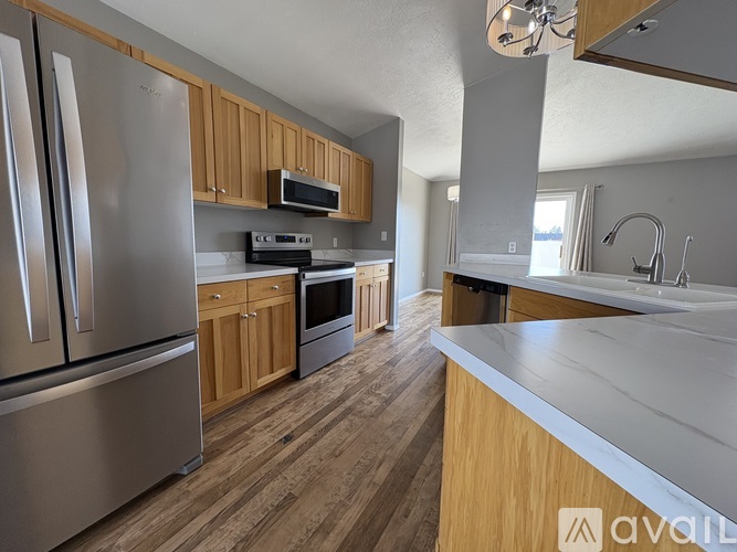 A kitchen with wooden cabinets and stainless steel appliances.
