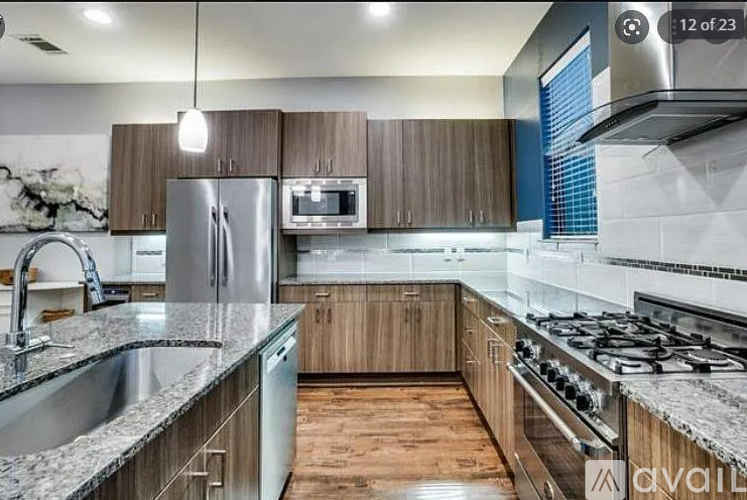 A modern kitchen with wooden cabinets and stainless steel appliances.
