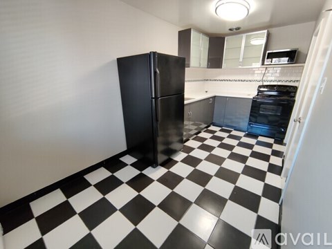 A black and white checkered floor in a kitchen.