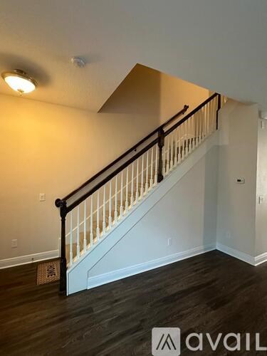 A staircase with a black railing and wooden steps.