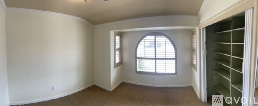 A room with a window and a door.