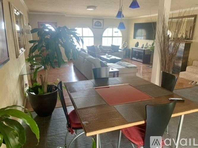 A dining room with a table and chairs.
