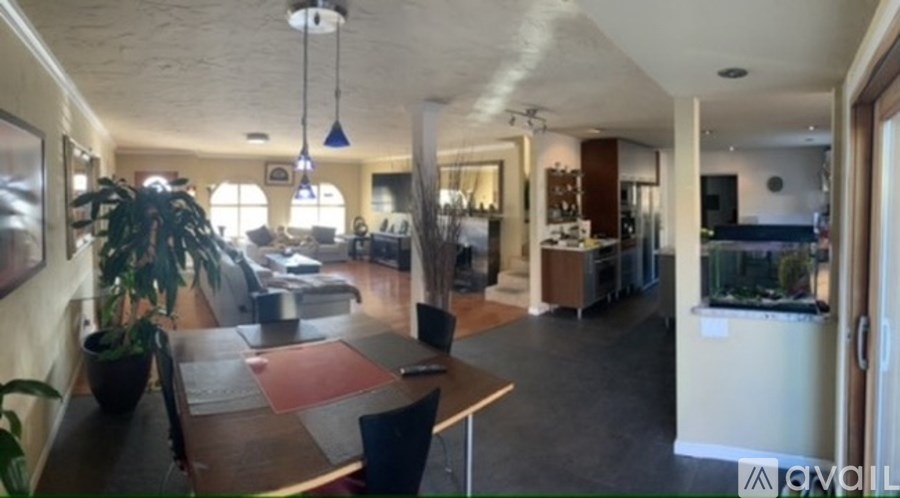 A living room with a dining table and chairs.