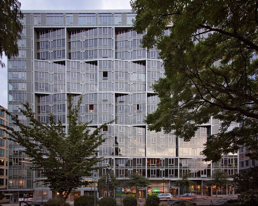 a view of a building with trees in front of it