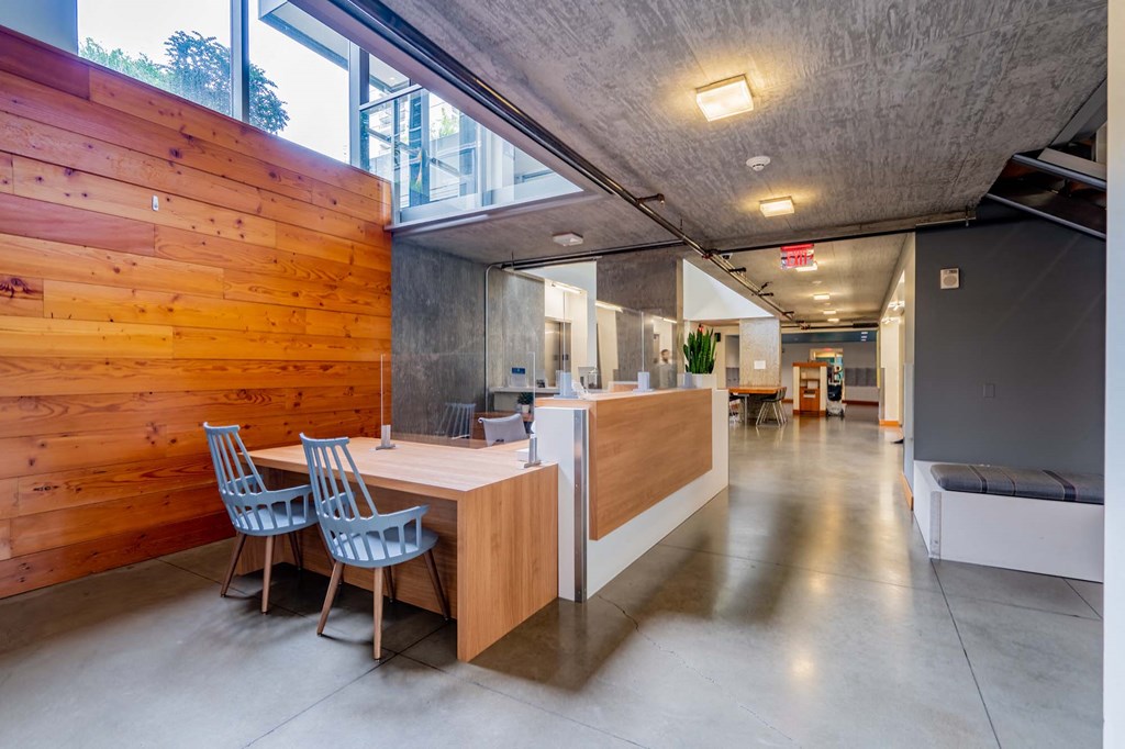 a dining room with a wooden table and chairs