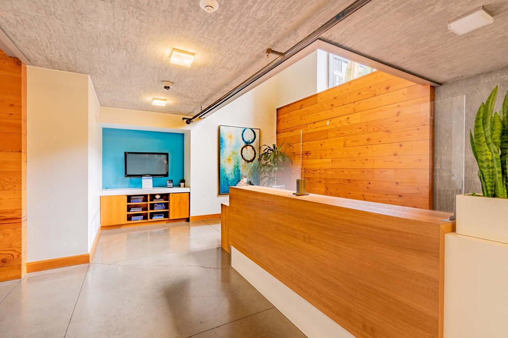 the lobby or reception area of a hotel with a wooden reception desk