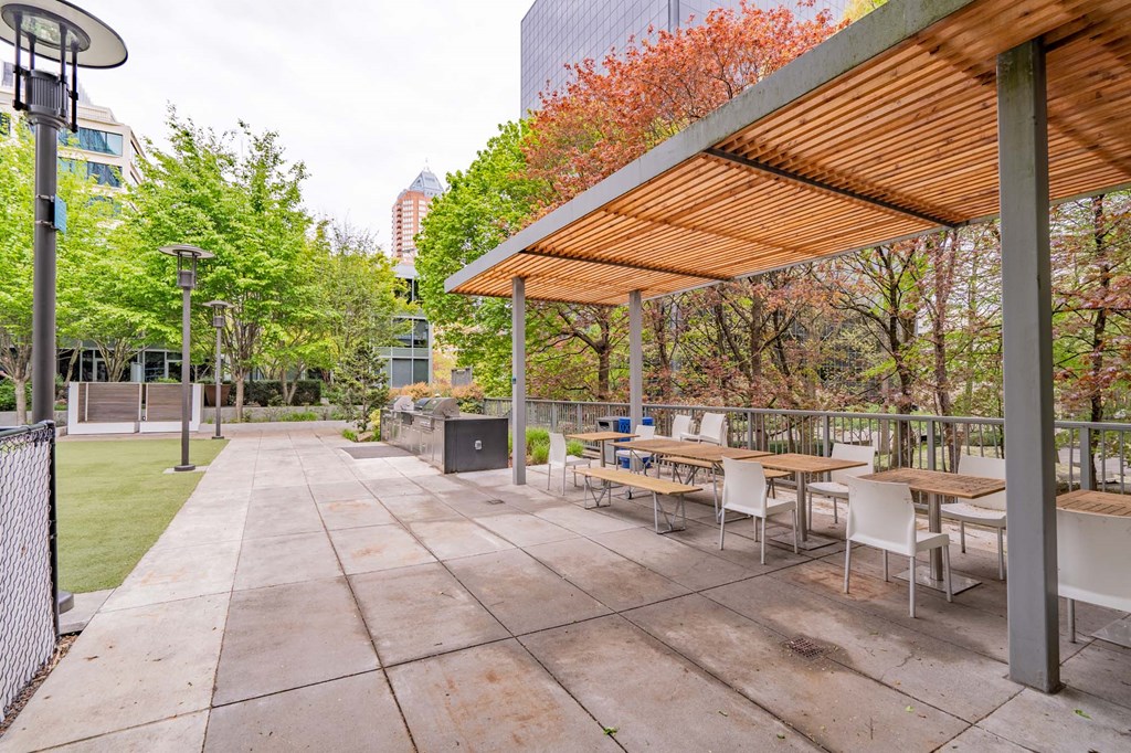 a patio with tables and chairs and a pergola
