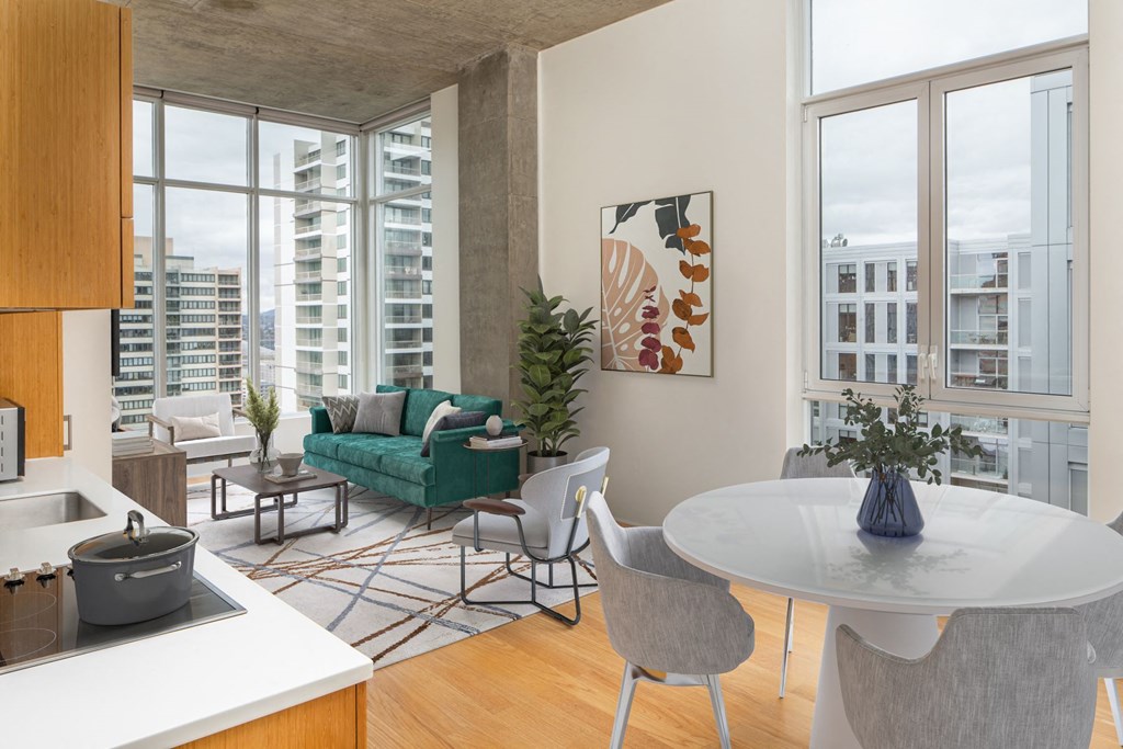 a living room with a large window and a table and chairs