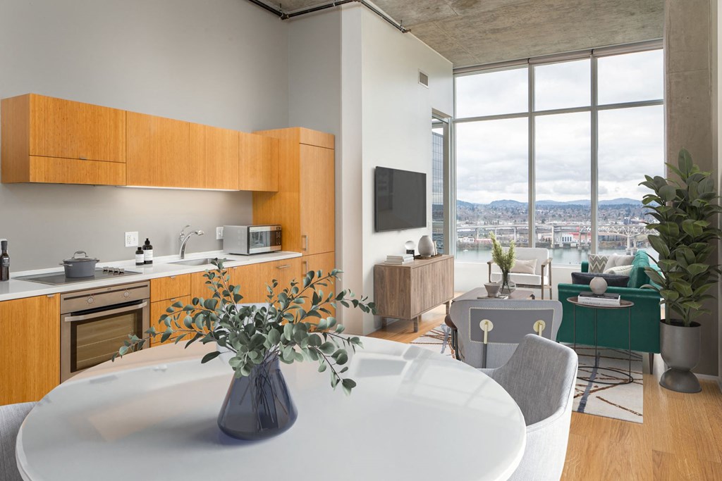 a kitchen and living room with a table and a vase