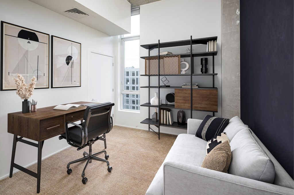 a home office with a desk and a couch