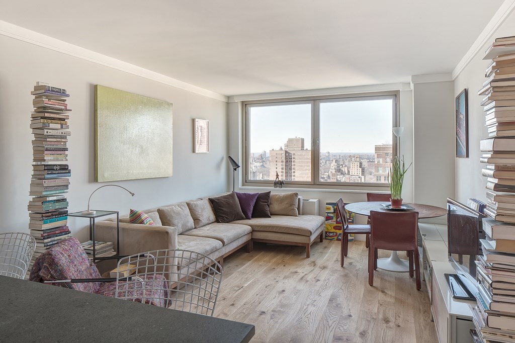 a living room with a couch and a table and a large window