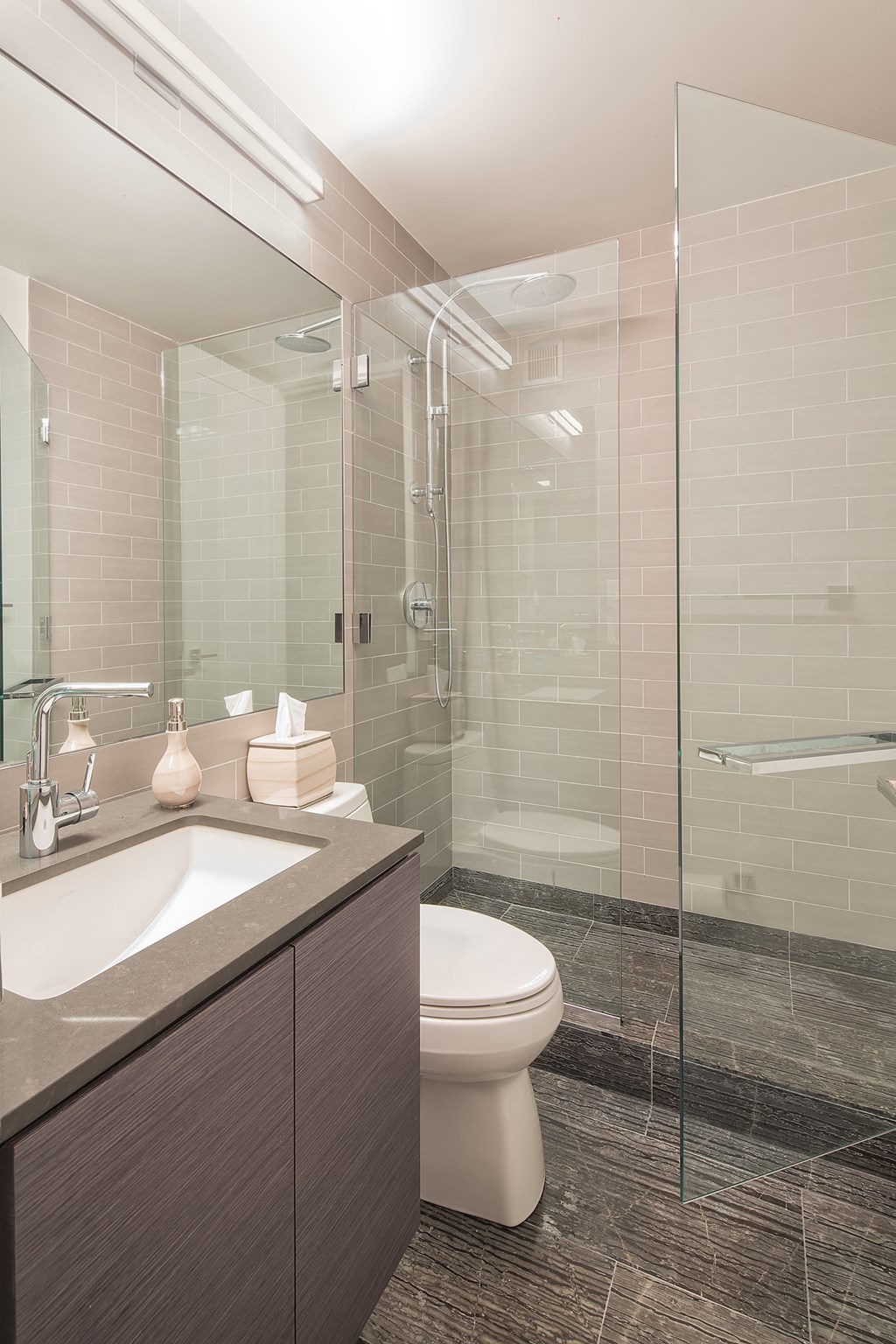 a bathroom with a toilet sink and shower