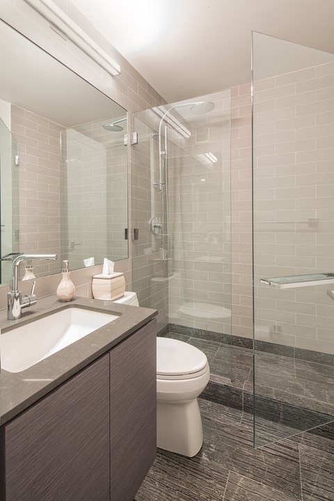a bathroom with a toilet sink and shower
