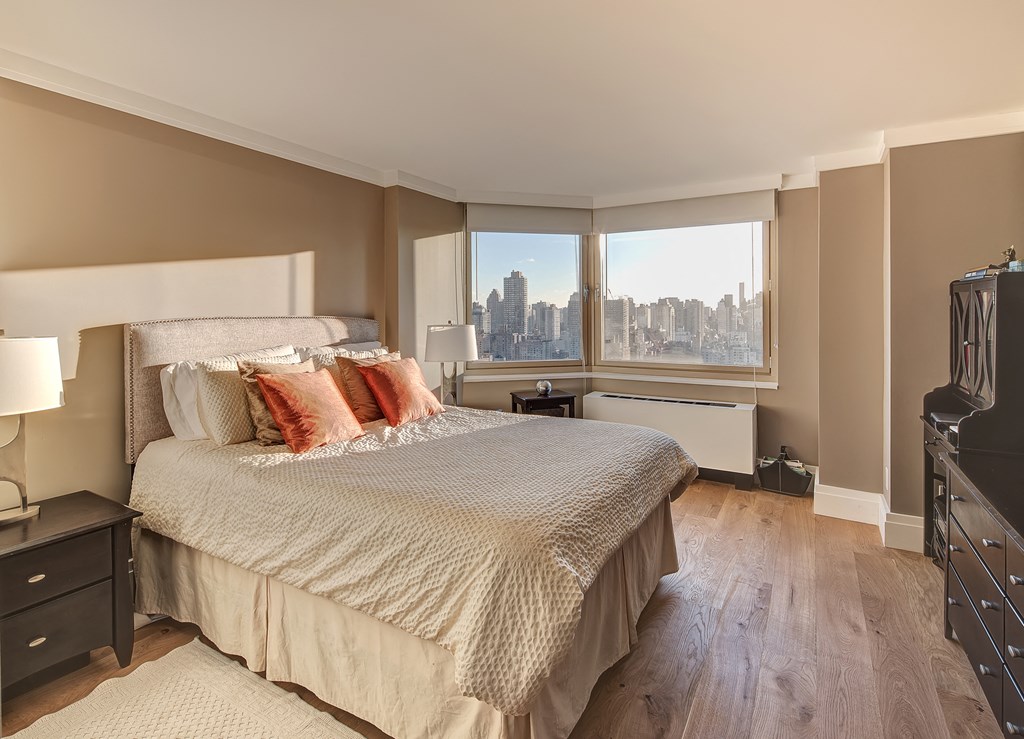 a bedroom with a large bed and a window