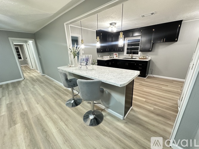 A kitchen with a table and chairs in the middle of the room.