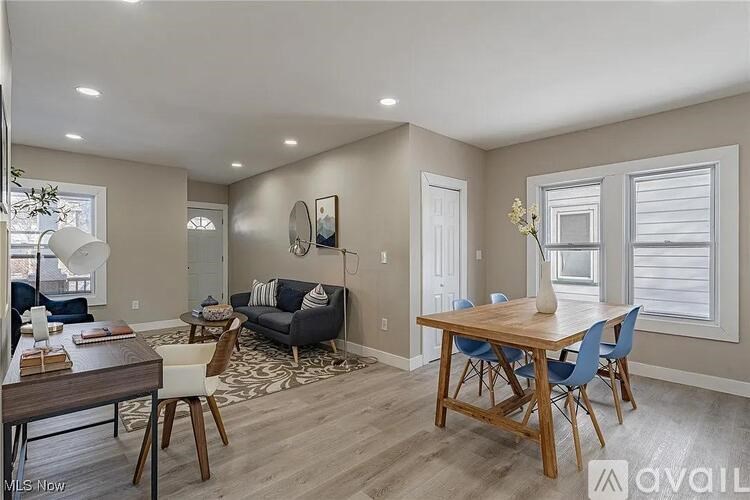 A living room with a dining table and chairs.