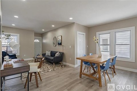 A living room with a dining table and chairs.