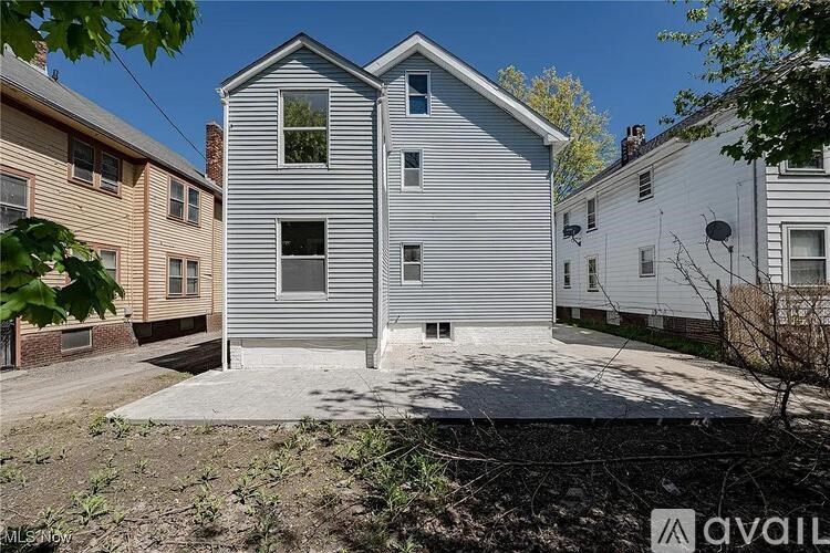 A two-story house with a grey exterior is for sale.