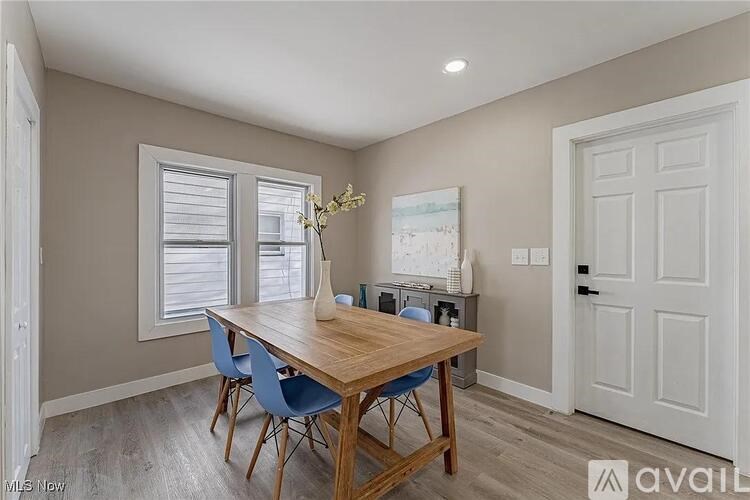 A dining room with a wooden table and blue chairs.