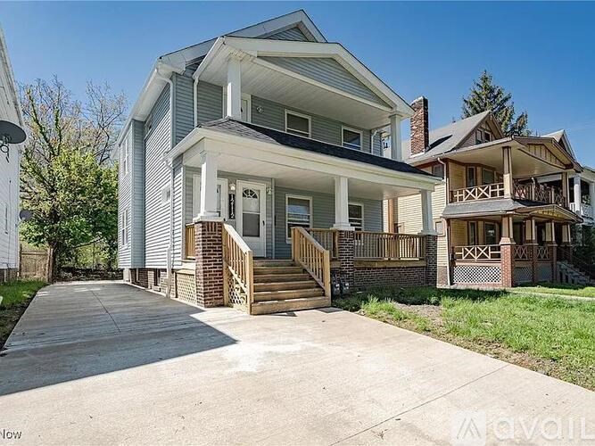 A two-story house with a porch and a balcony.