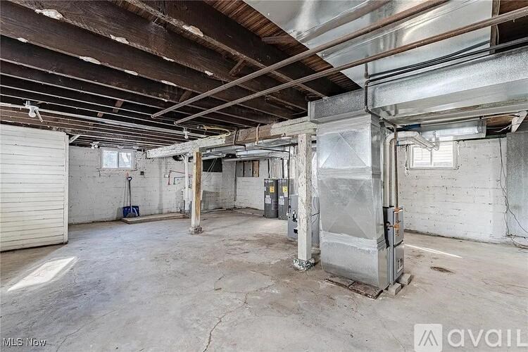 A large, empty warehouse with a high ceiling and exposed beams.