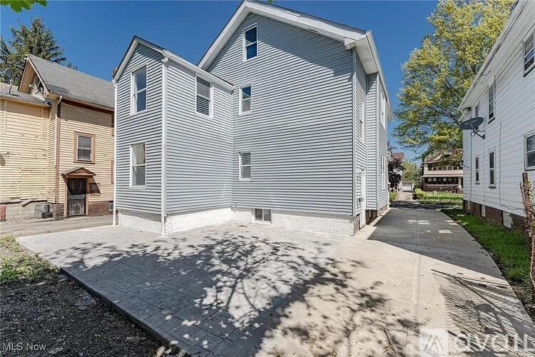 A two-story house with a garage is for sale.