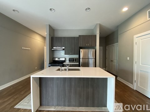 A modern kitchen with a white island in the middle.