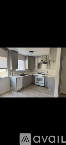 A modern kitchen with white appliances and a large island.
