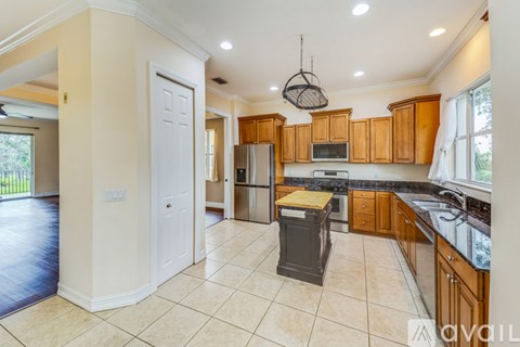 A kitchen with wooden cabinets and a black stove top oven.