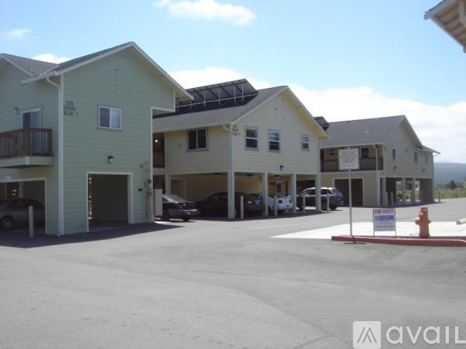A row of houses with a sign that says "available" in front of them.