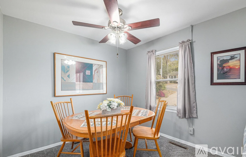 A dining room with a table set for four.