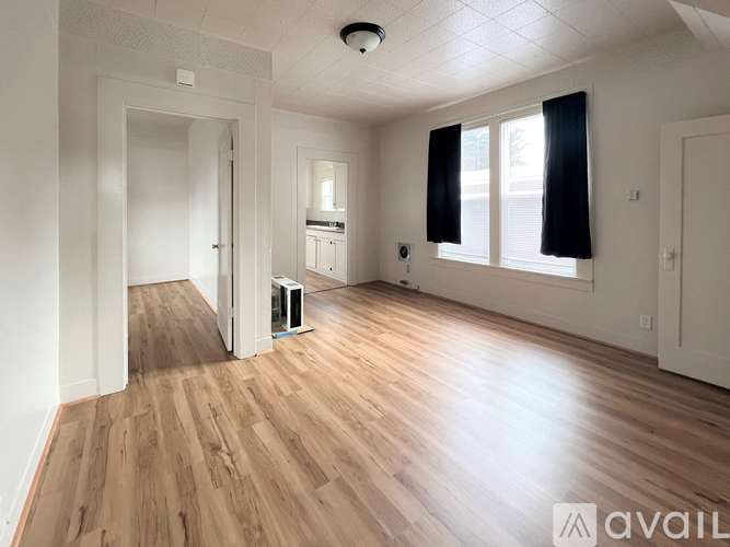 A room with wooden floors and white walls.