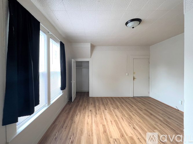 A room with wooden floors and white walls.