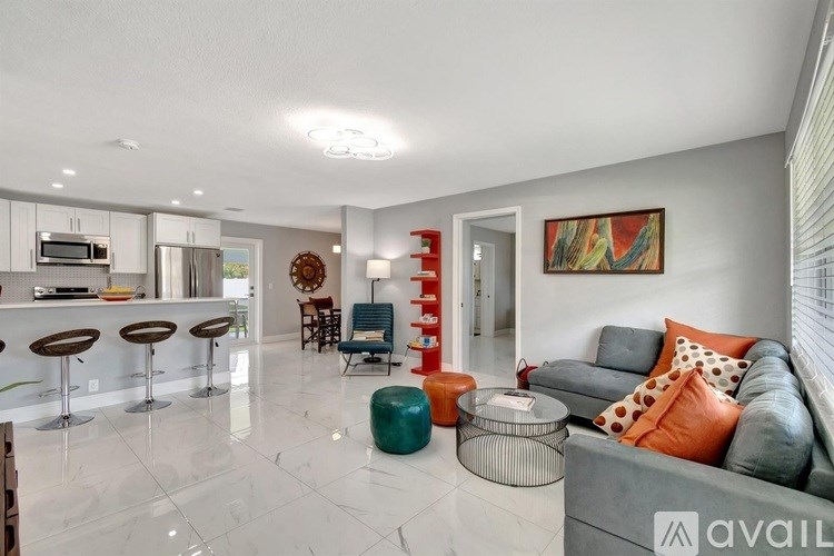 A modern living room with a bar area and a couch.