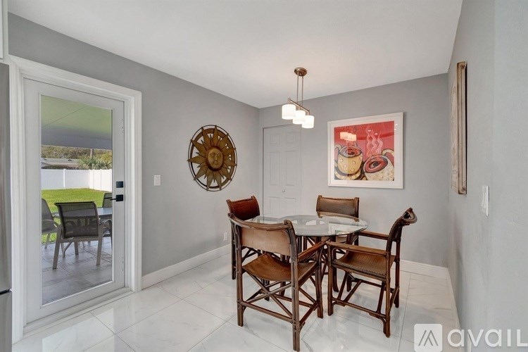 A dining room with a table set for four.
