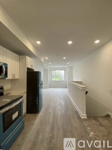 A kitchen with a refrigerator and an oven.