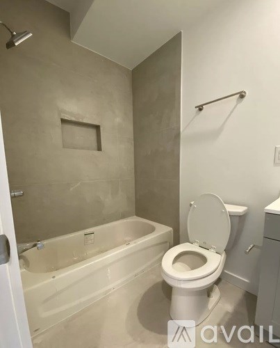 A bathroom with a tub and toilet.
