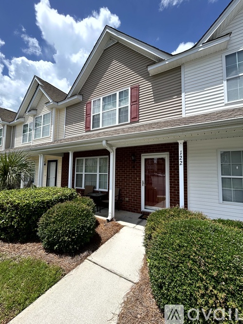 A house with a red door and a white garage door.