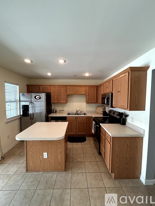 A kitchen with wooden cabinets and a white island.