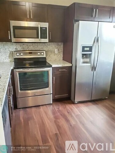 A kitchen with a stainless steel refrigerator and oven.