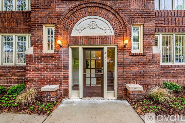 A brick building with a large arched entrance and a number 405 on the door.